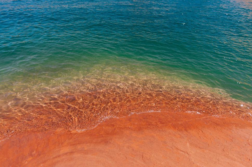 Free Image of Crystalline waters meeting a sandy shore 