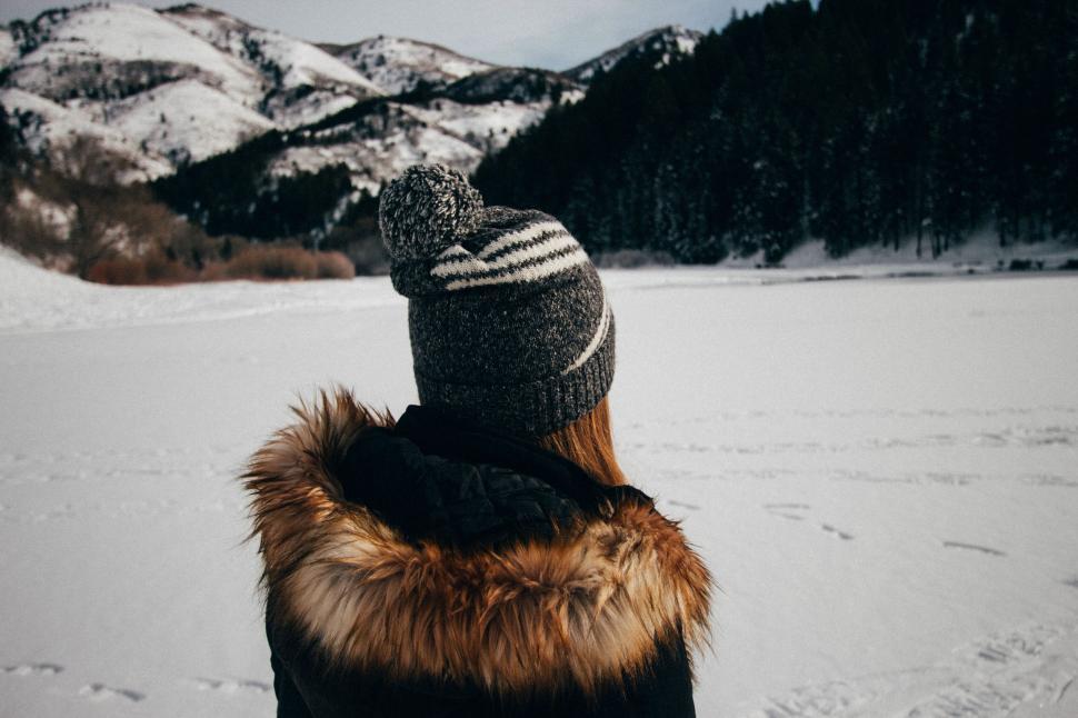 Free Image of Woman gazing at snowy mountain landscape 