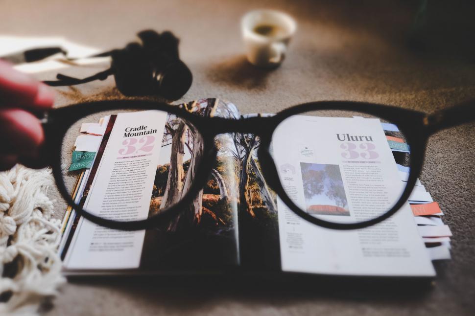 Free Image of Close-up of glasses on magazine spread 