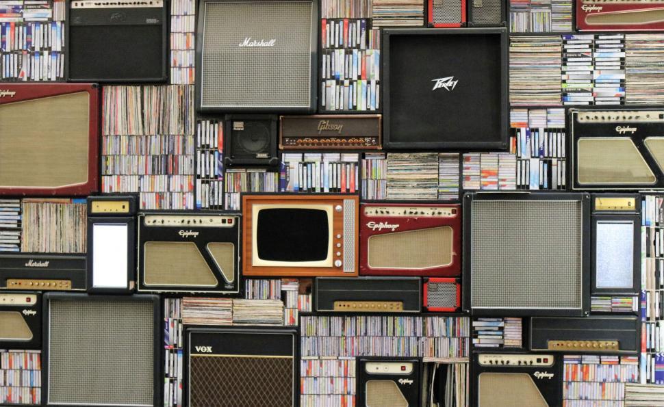 Free Image of Wall of vintage amplifiers and piled CDs 