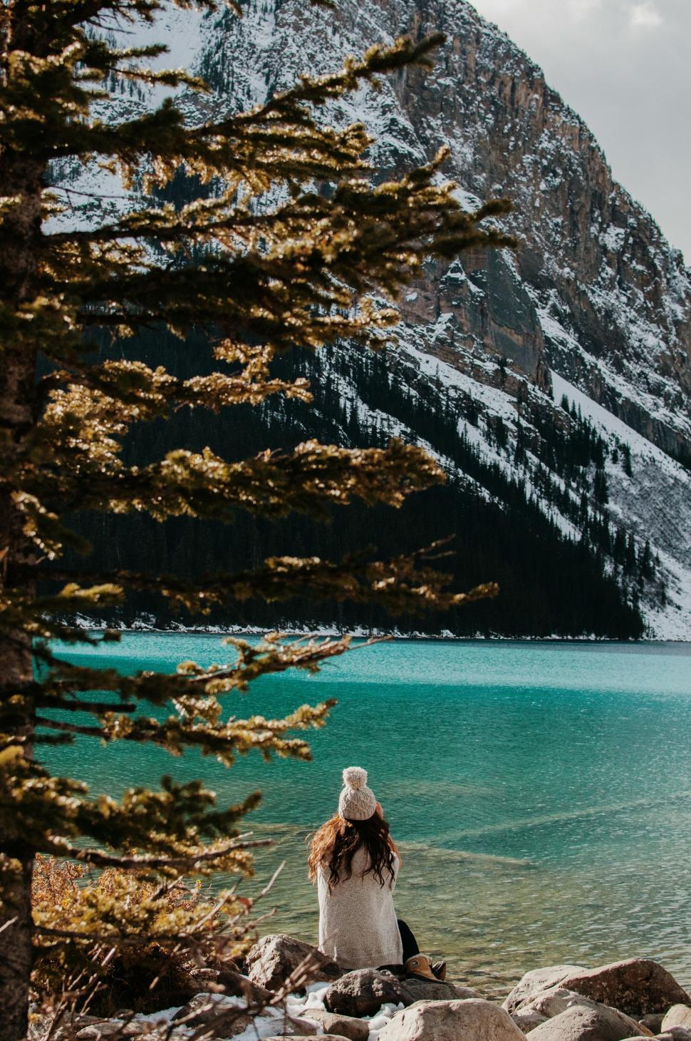 Free Image of Woman Admiring Majestic Mountain Lakeside 