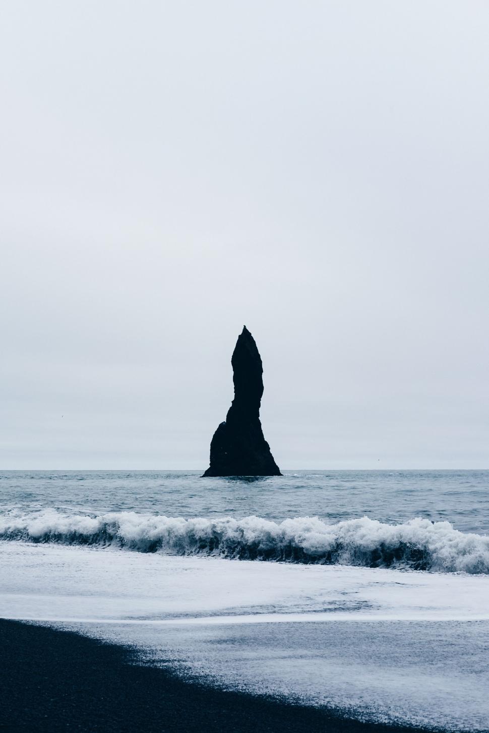 Free Image of Monolith Rock Formation on a Misty Black Beach 