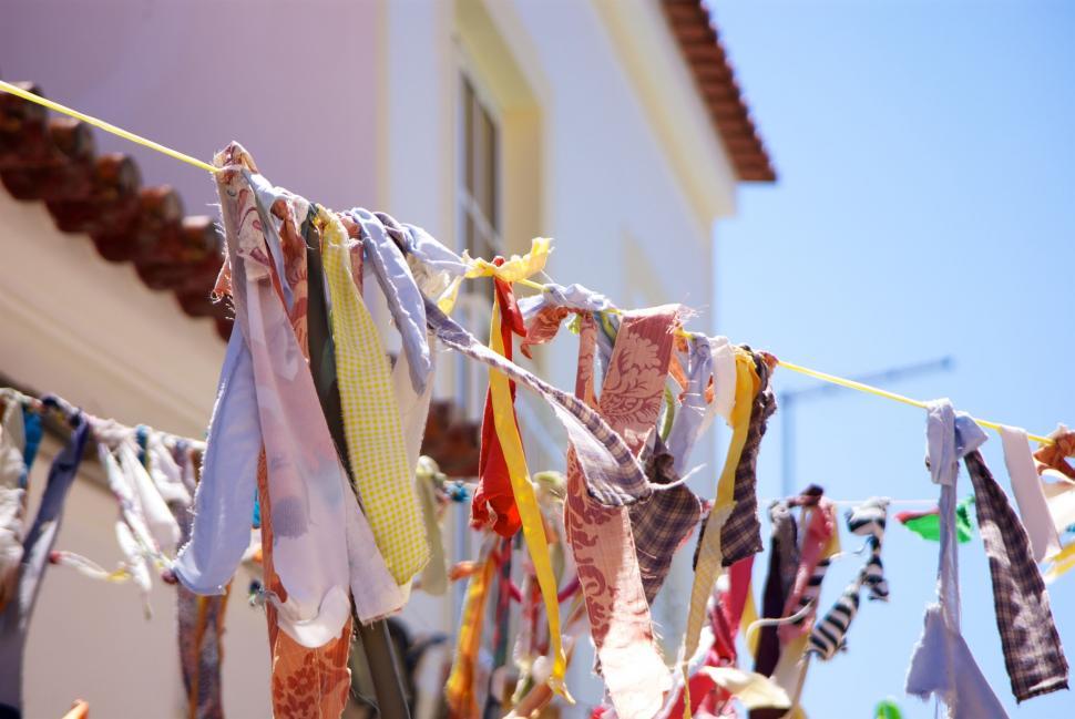Free Image of Colorful laundry hanging against blue sky 