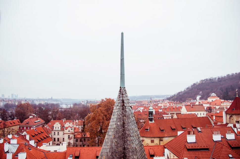 Free Image of Prague skyline with conical spire and rooftops 