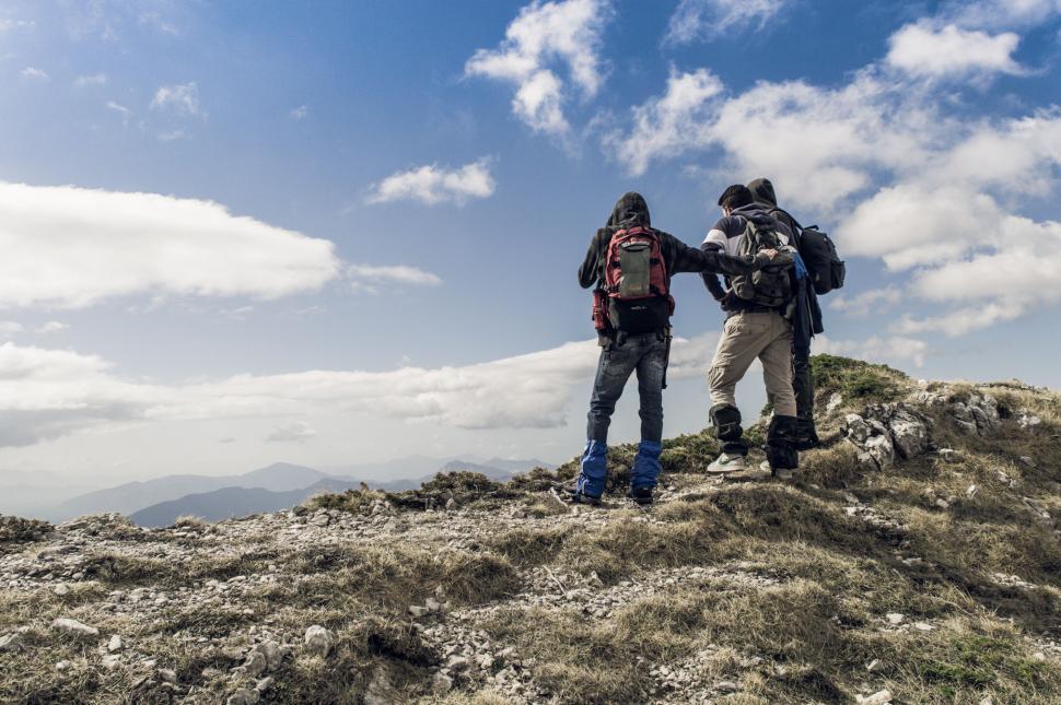 Free Image of Hikers supporting each other on mountain 