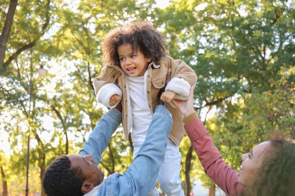 Free Image of Family uplifting child in the park 