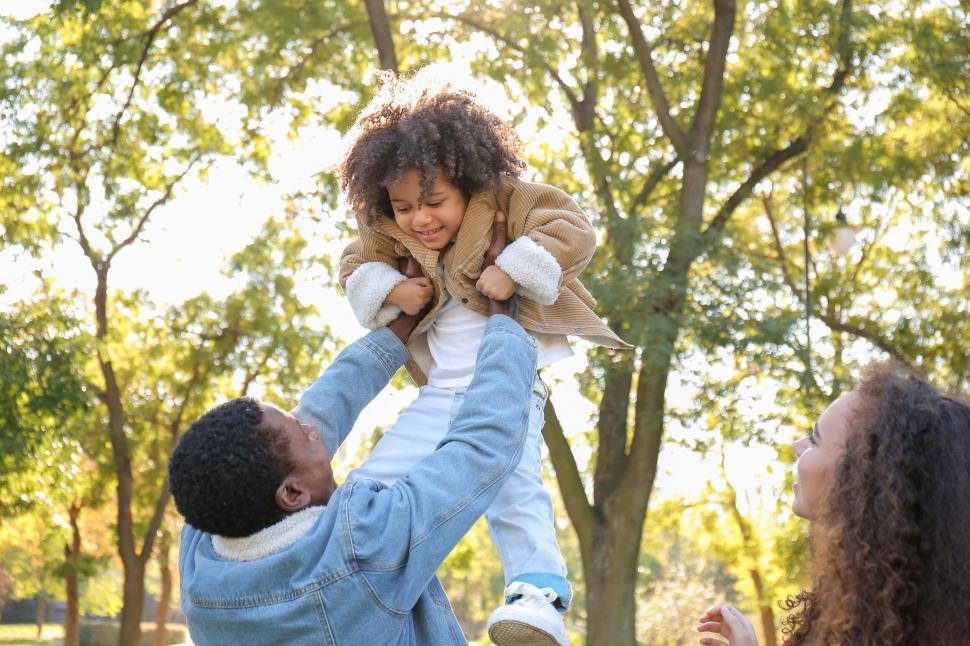 Free Image of Family playing with child outdoors 