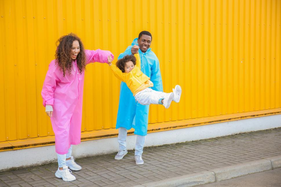 Free Image of Family having fun in colorful raincoats 