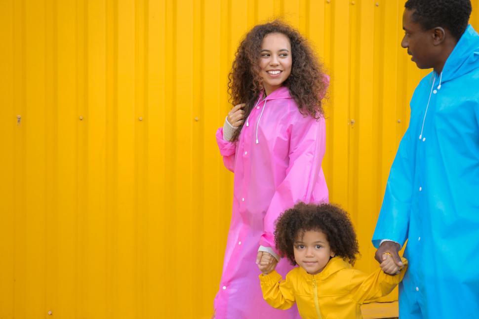 Free Image of Family in colorful raincoats walking 