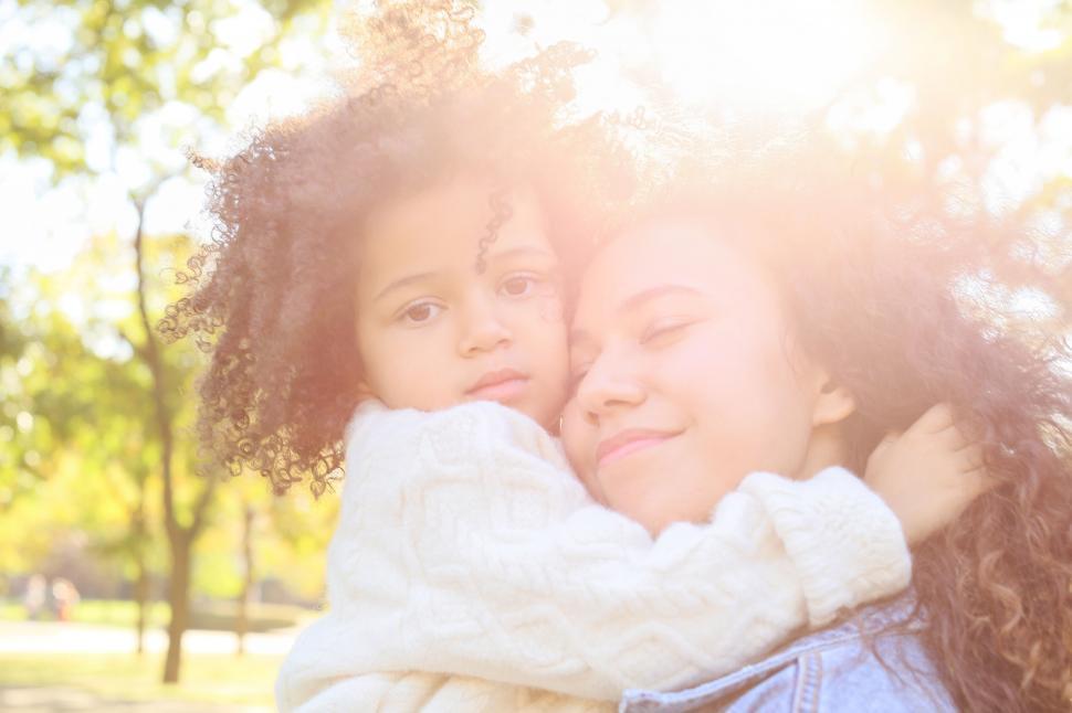 Free Image of Sunlit mother and child embracing 