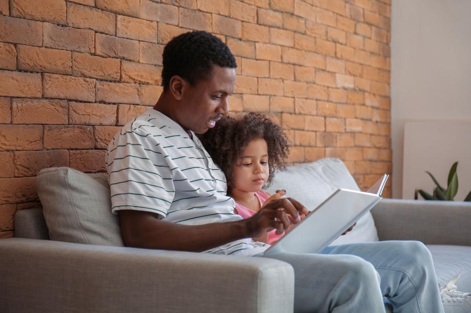 Free Image of Father and child engaging with laptop at home 