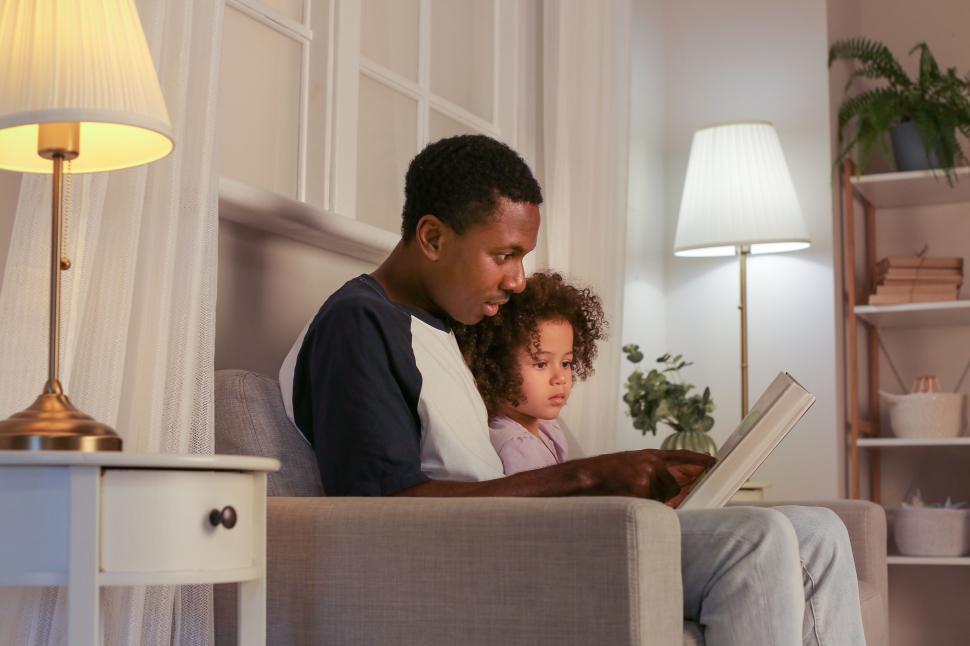 Free Image of Father-daughter reading time in a serene room 