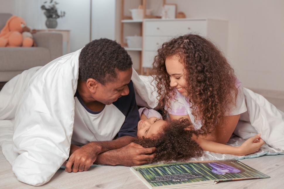 Free Image of Playful dad and daughter with a puzzle on floor 