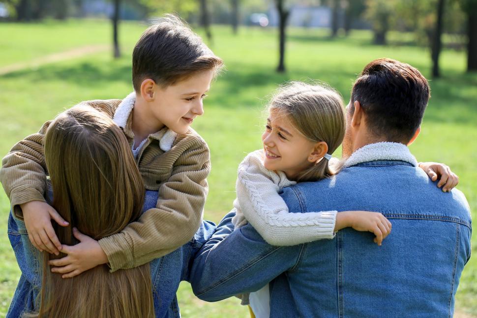 Free Image of Family with children hugging outdoors 