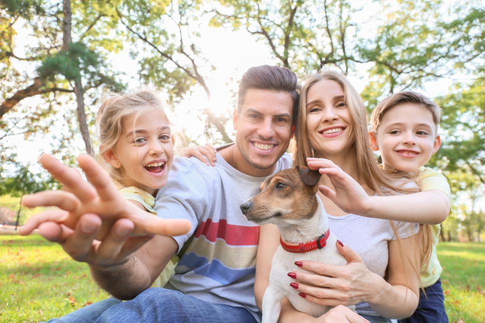 Free Image of Happy family with dog stretching hands camera 