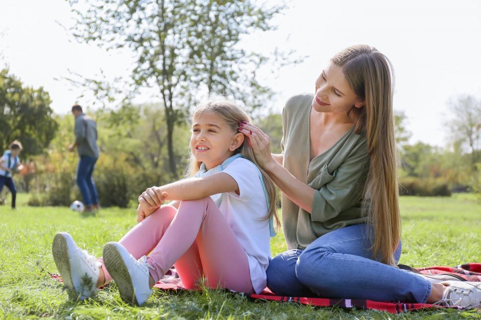Free Image of Mother braiding daughter s hair in park 
