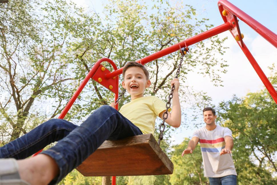Free Image of Boy having fun on a swing in park 