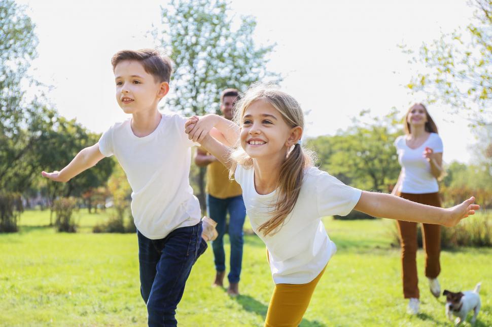 Free Image of Kids and parents running in the park 