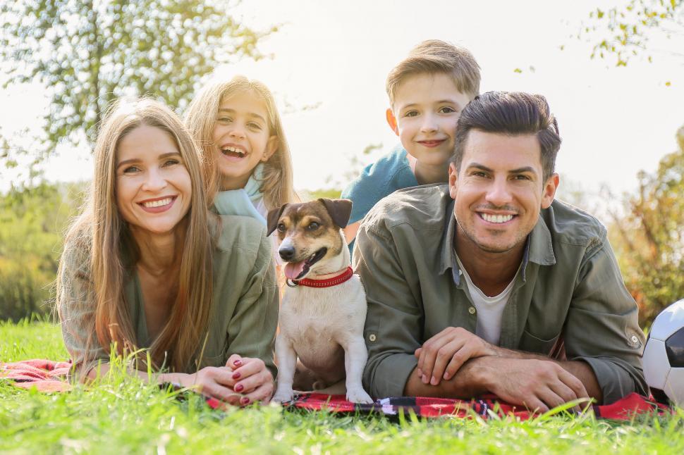 Free Image of Family with dog having picnic in park 