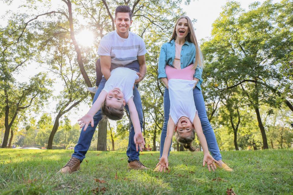 Free Image of Family doing upside-down play in a park 