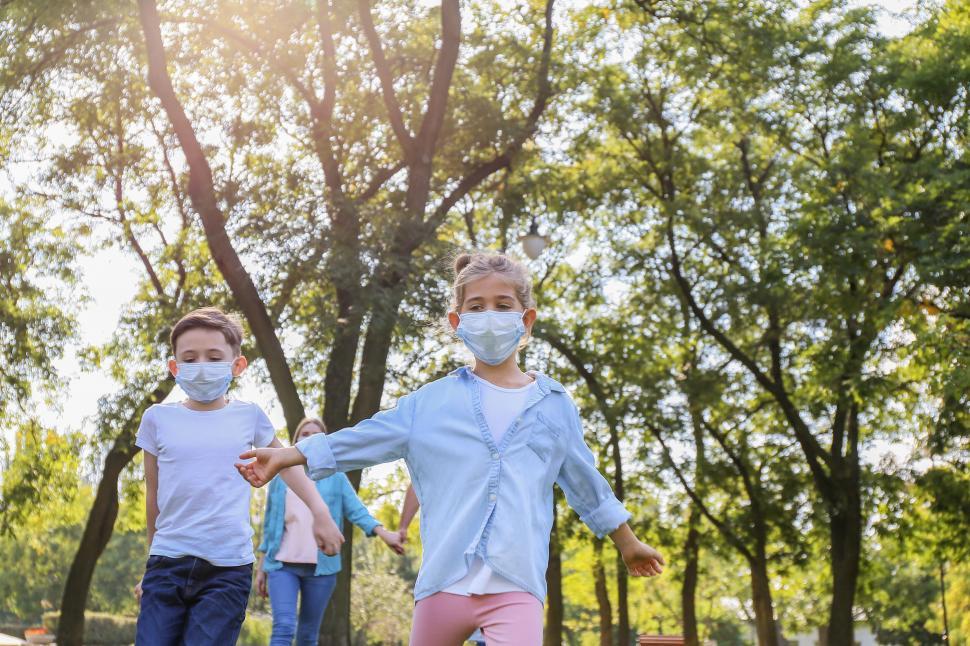 Free Image of Children running with masks in park 