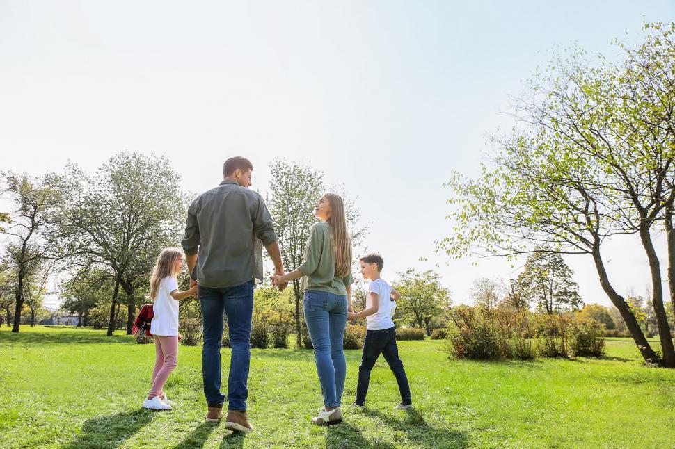 Free Image of Family walking together in sunny park 