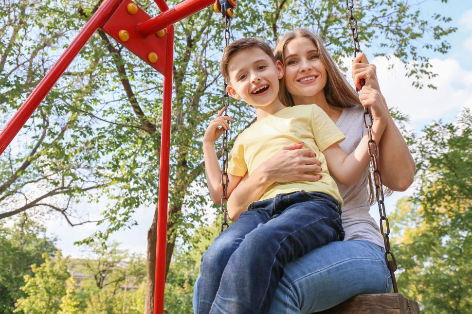 Free Image of Mother and son swinging in the park 