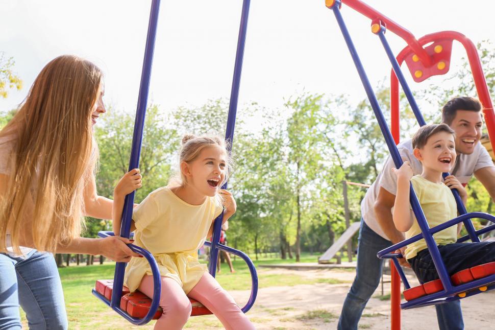 Free Image of Family fun on a swing at the park 