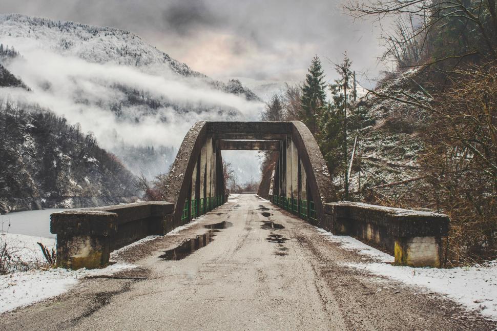 Free Image of Snow-covered bridge in mountain landscape 