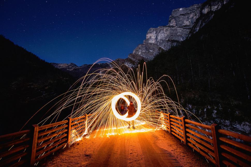 Free Image of Light painting on a mountain bridge at night 