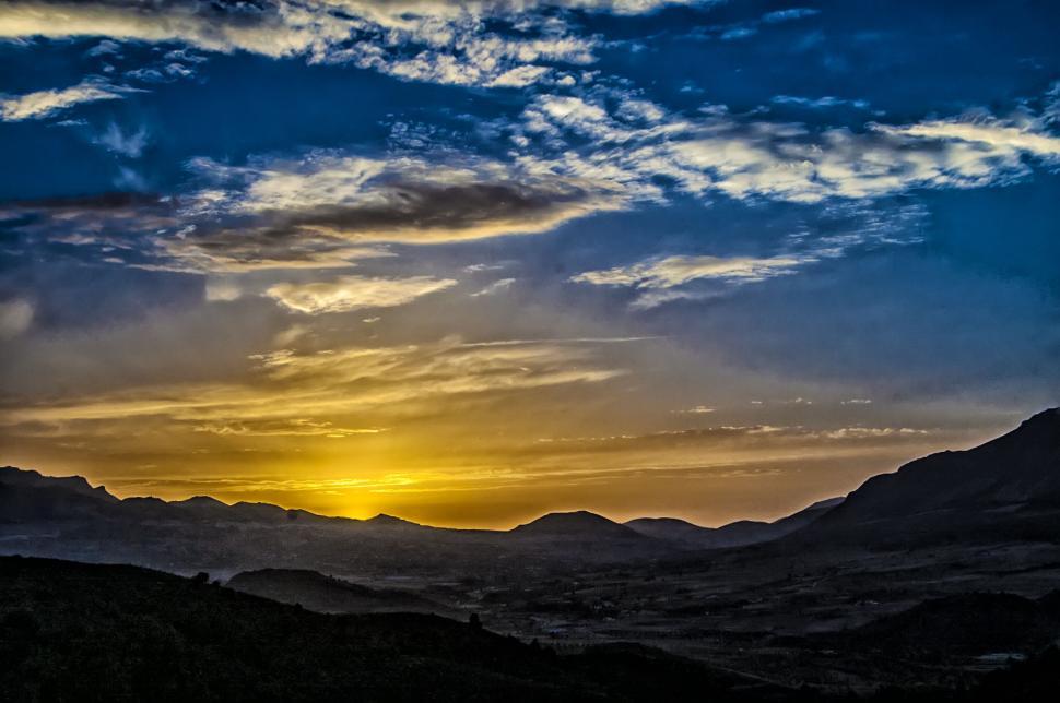 Free Image of Sunset silhouette over mountainous landscape 