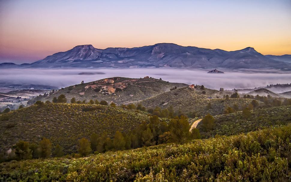 Free Image of Misty dawn over a rural mountain range 