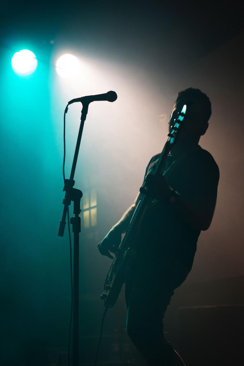 Free Image of Silhouette of a musician on stage 