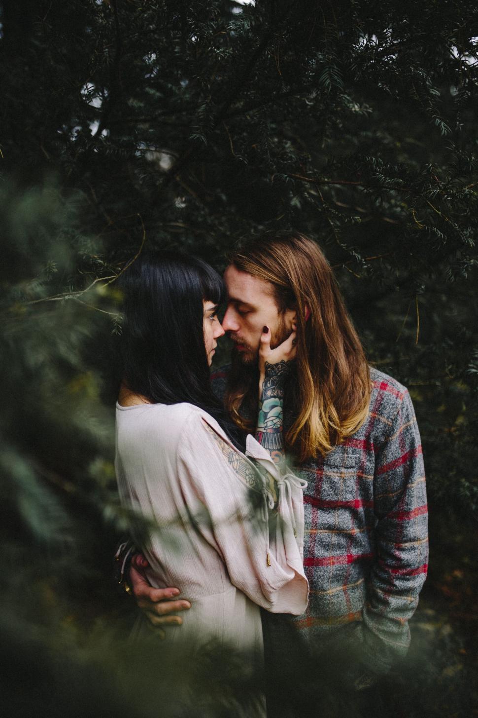 Free Image of Intimate couple embraced in forest setting 