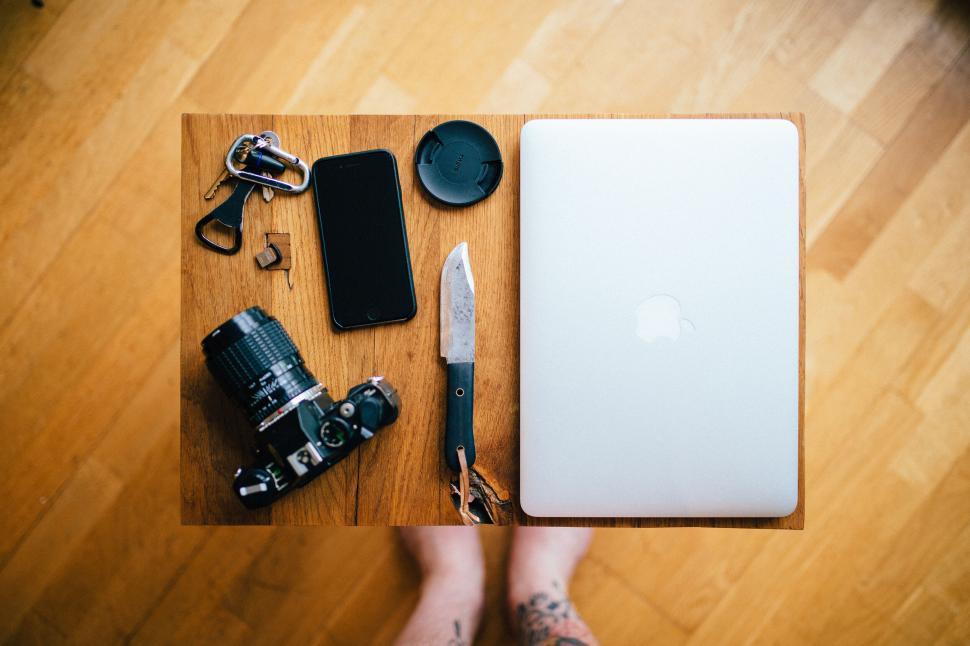 Free Image of Tech gadgets and camera on wooden table 