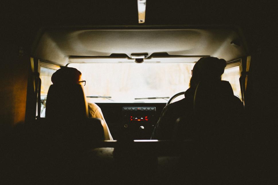 Free Image of Silhouette of two people in a car 