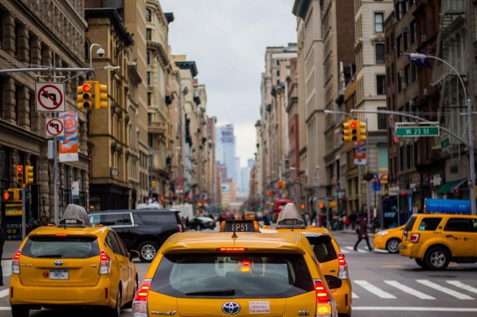 Free Image of Yellow taxis line busy New York City street 