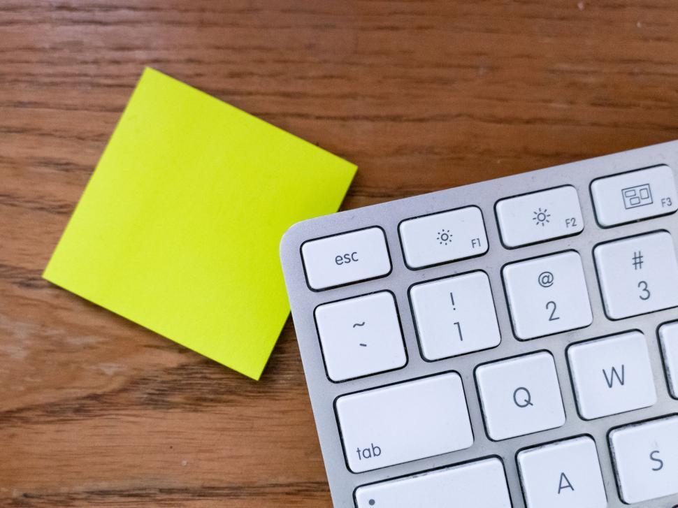 Free Image of Workspace with sticky note and white keyboard 