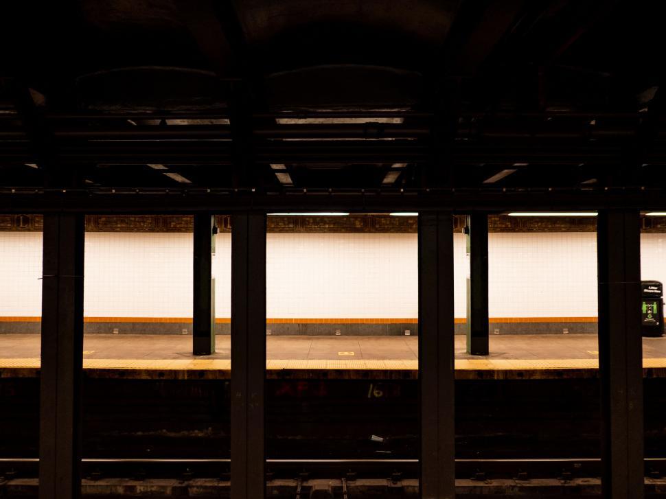 Free Image of Deserted subway platform in warm tones 