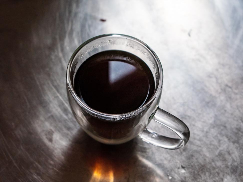 Free Image of Clear glass mug filled with dark coffee on table 