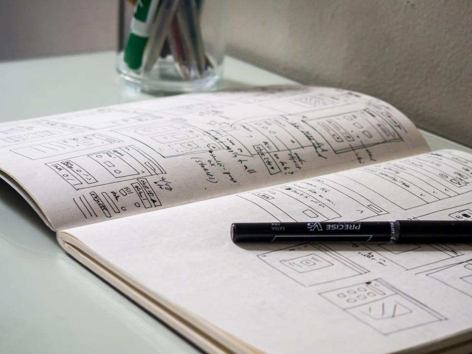 Free Image of Sketchbook with UIUX wireframe designs 