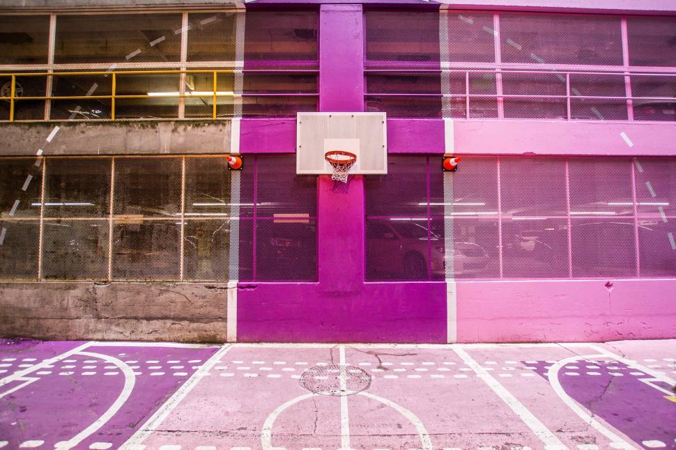 Free Image of Bright purple basketball court in urban setting 