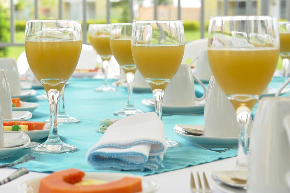 Free Image of Elegant table setting with orange juice glasses 