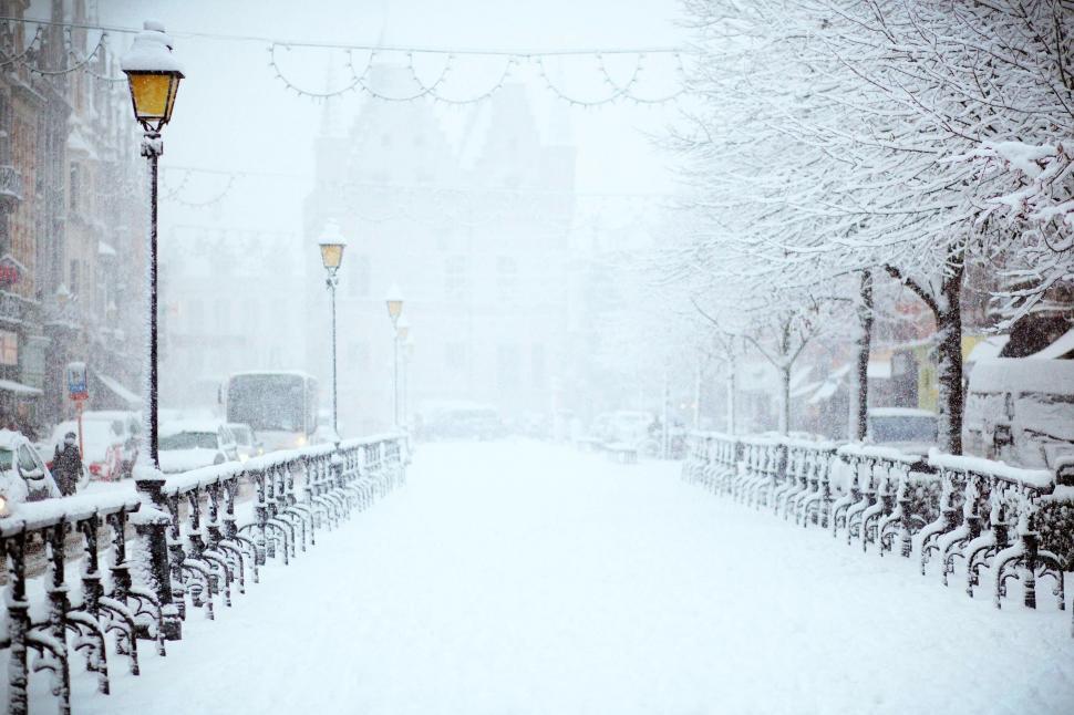 Free Image of Snow-covered city street with warm lights 