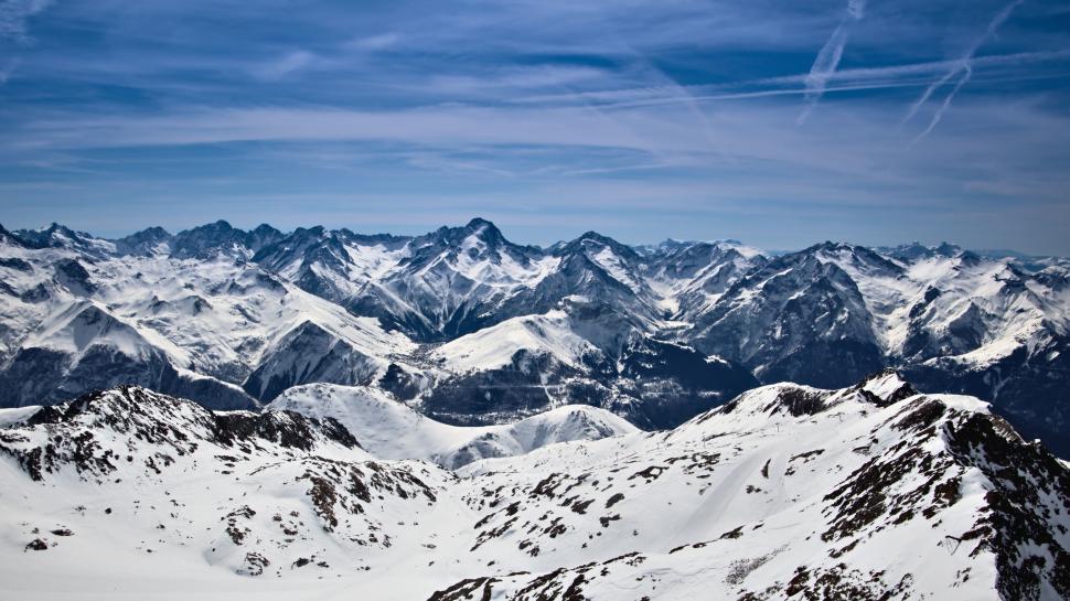 Free Image of Majestic snow-capped mountain peaks under blue sky 
