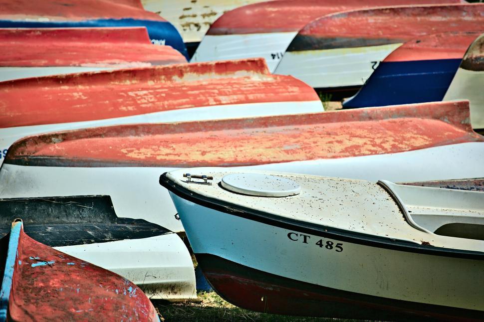 Free Image of Colorful stacked boats awaiting their next voyage 