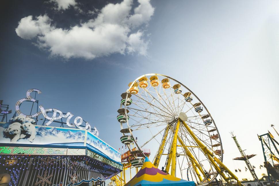 Free Image of Ferris wheel on a vibrant fairground scene 