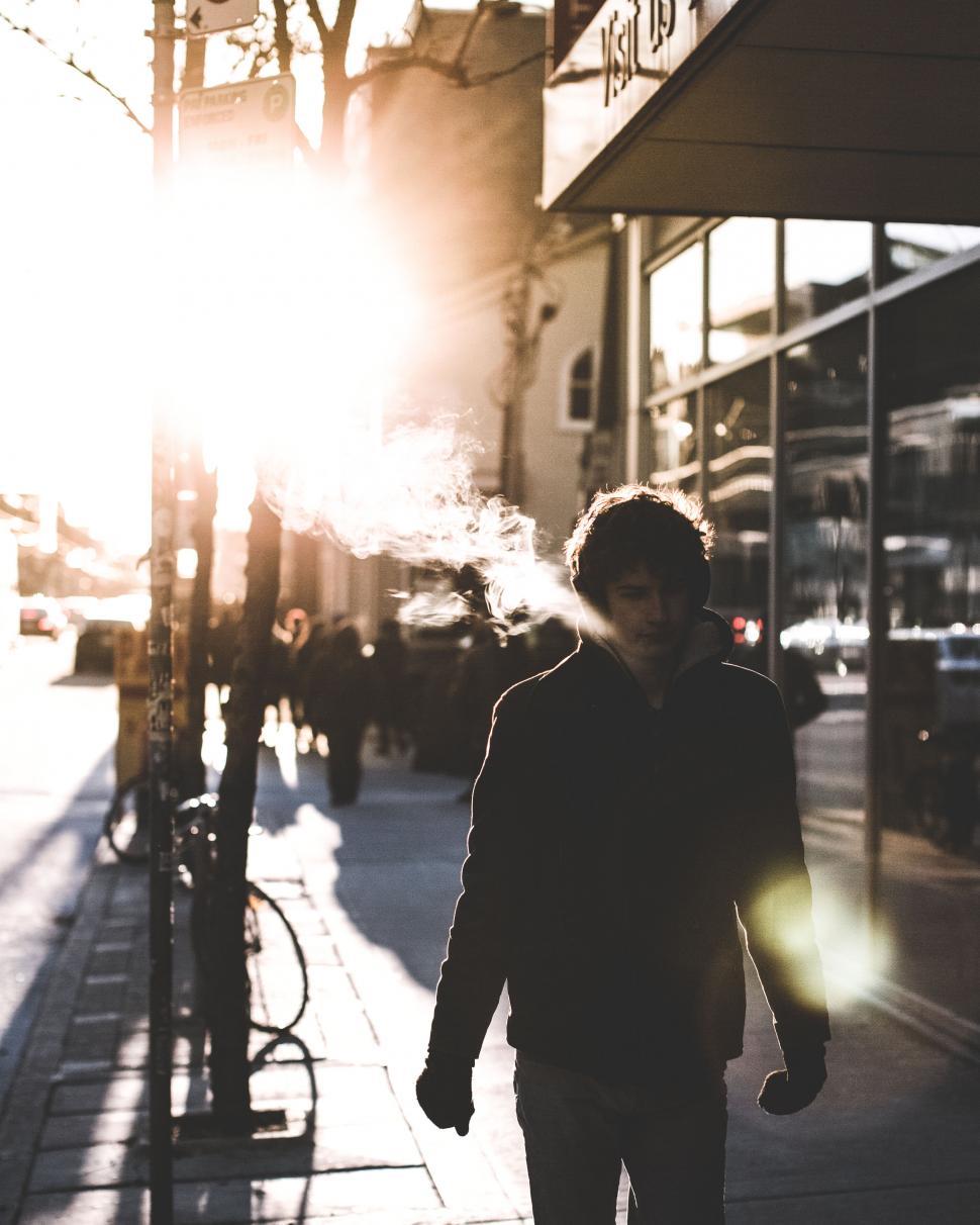 Free Image of Urban street scene with silhouette in sunlight 