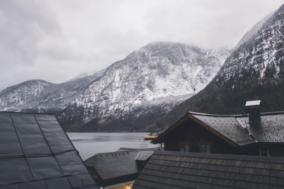 Free Image of Snowy mountain view from a rustic cabin 