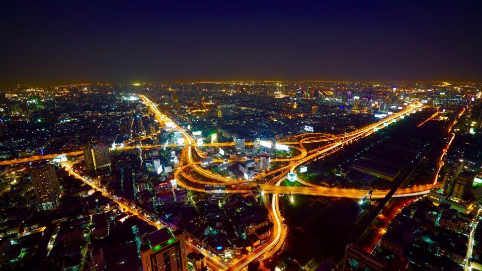 Free Image of Aerial view of cityscape with illuminated roads 